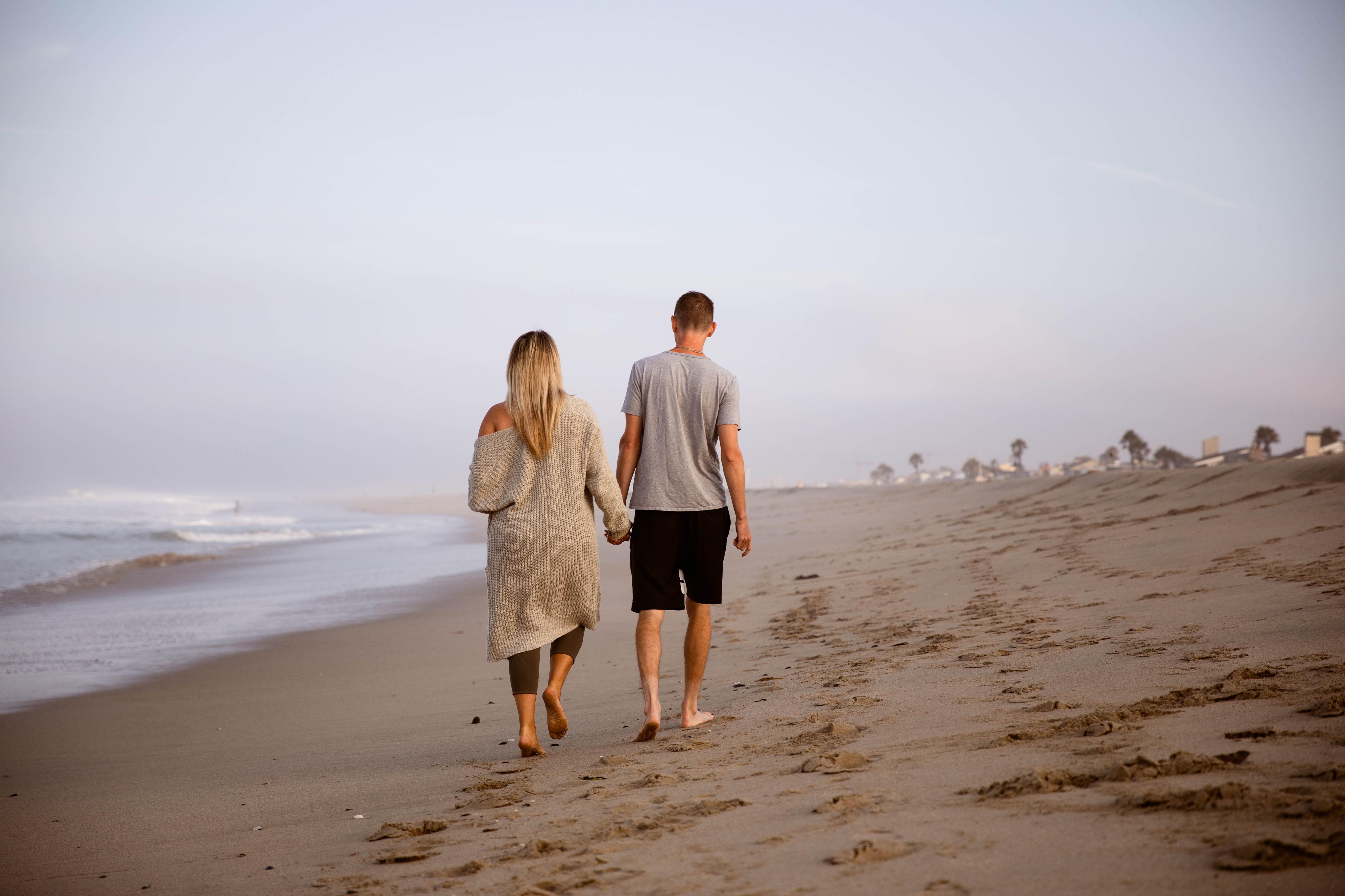couple walking away Newport Beach photography sunrise