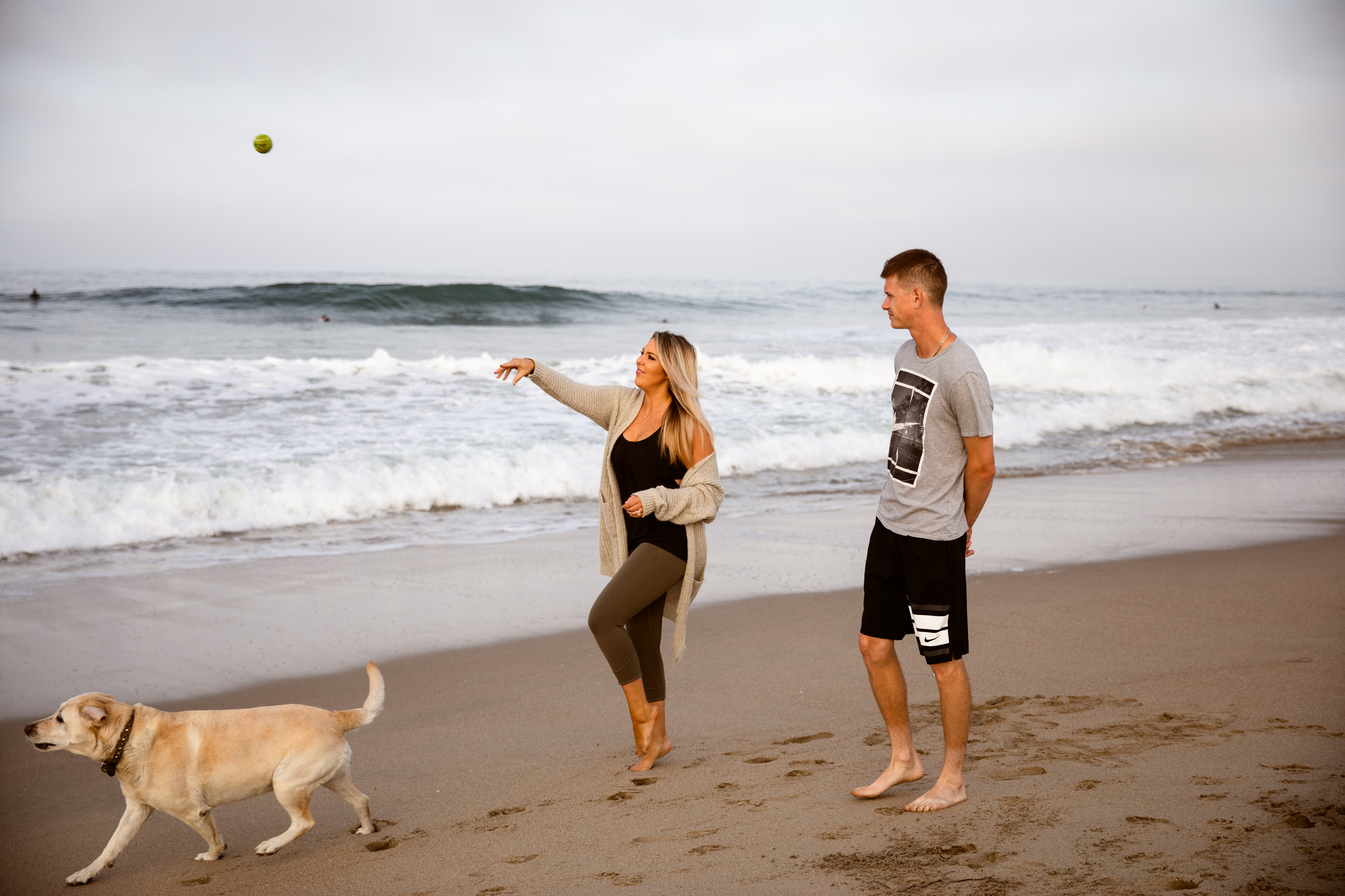 Newport Beach couple walking playing fetch with dog