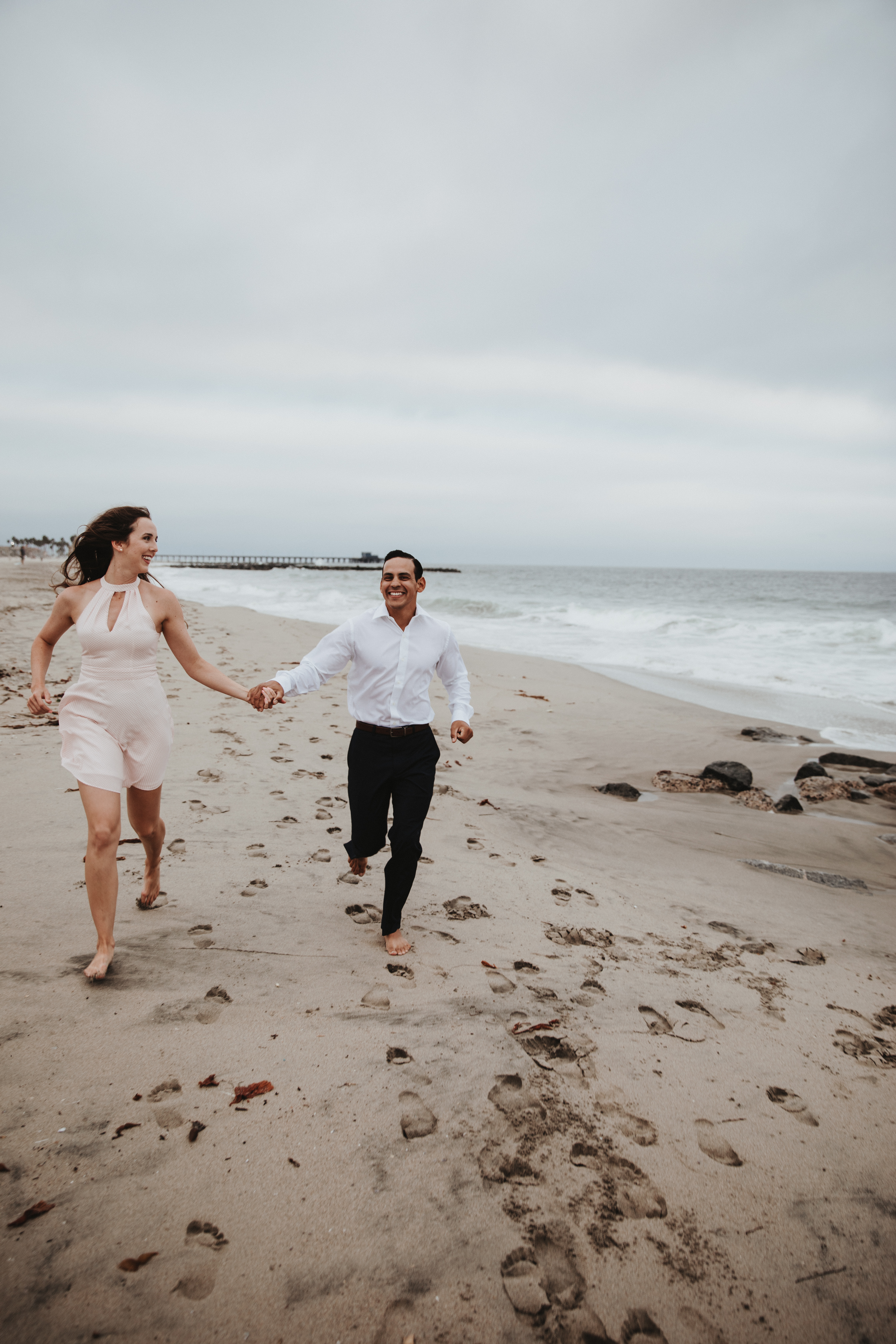 Newport Beach couple engagement photography happy walking beach smiling love