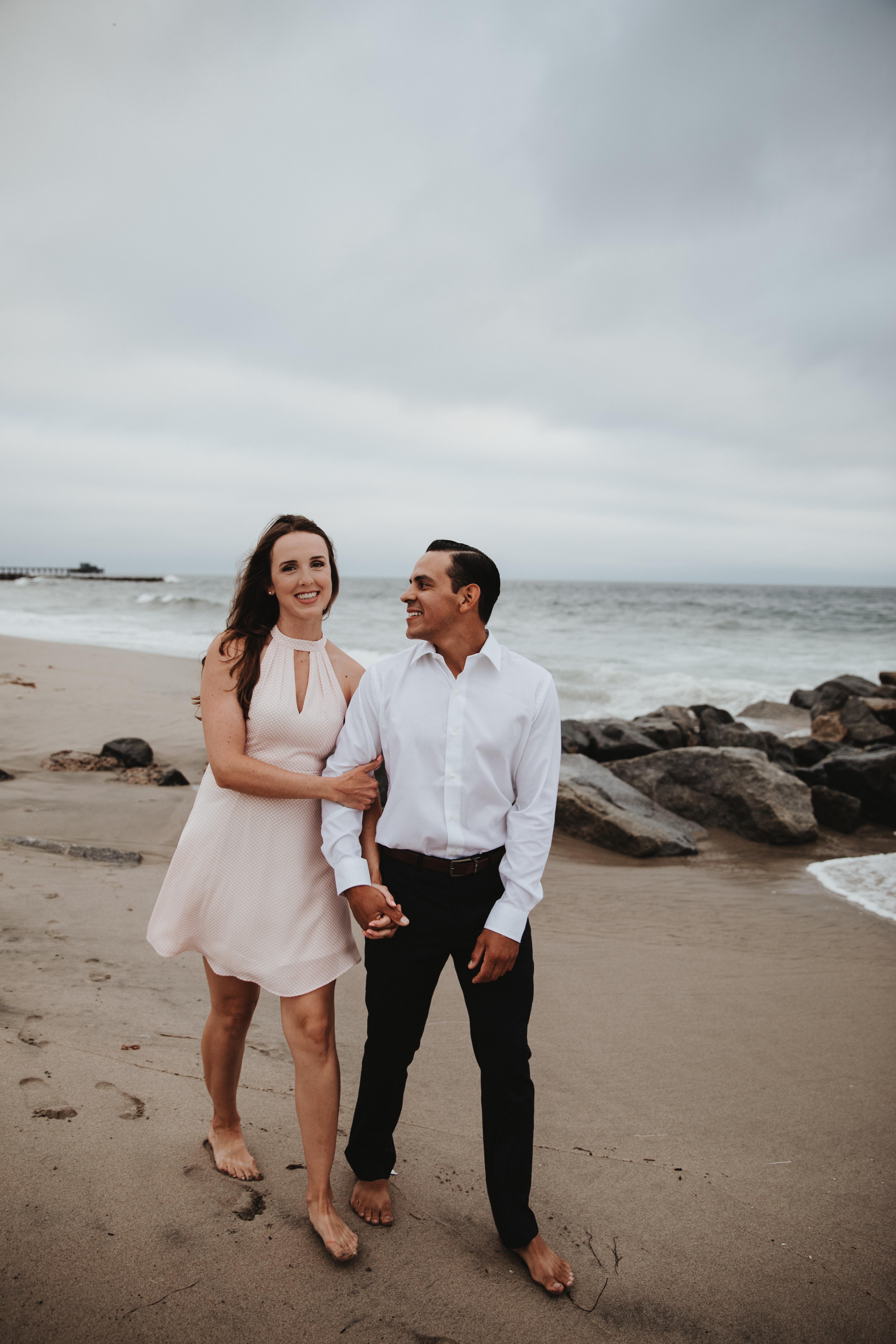 Newport Beach couple engagement photography happy walking beach smiling love