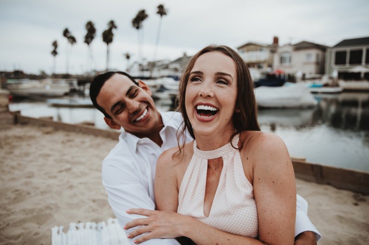 Newport Beach couple engagement photography happy walking beach smiling love